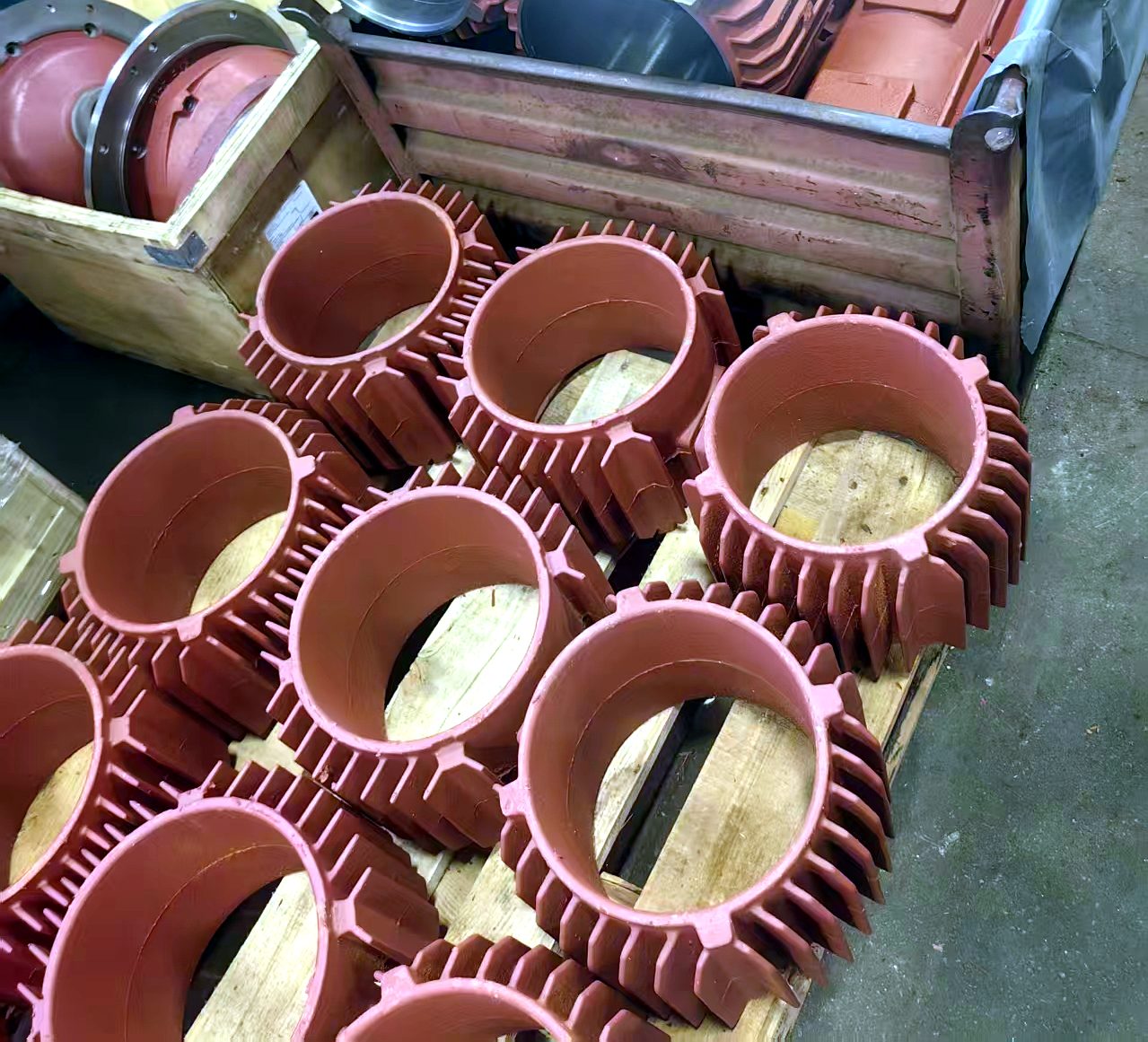 Batch of cast motor housings with cooling fins — castings for electric motor and hoist parts